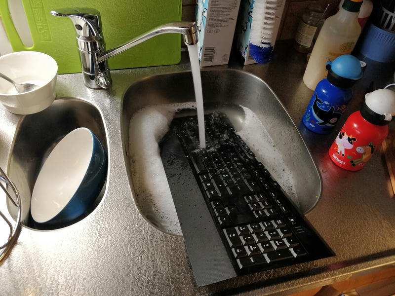 This is a story of washing a keyboard. I mean, repairing a keyboard. But I also washed it, so have a photo of my submerged keyboard. No, it's not water-resistant.